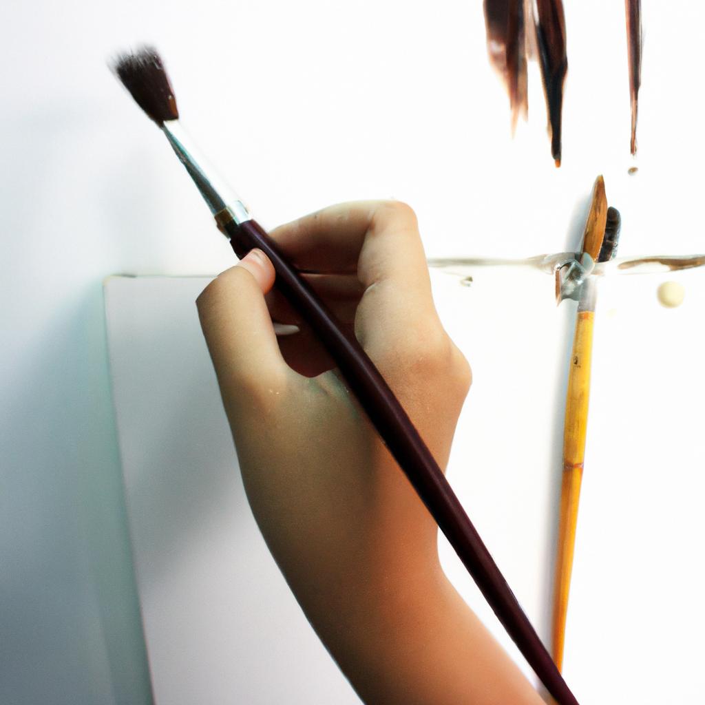 Person holding paintbrush, creating artwork